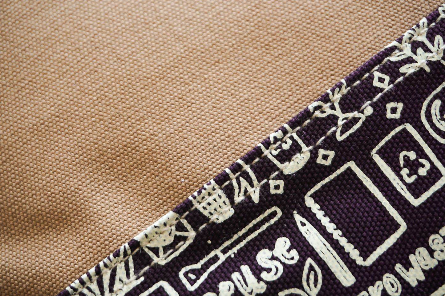 Sustainable canvas laptop bag with tan handle, eco-friendly and affordable