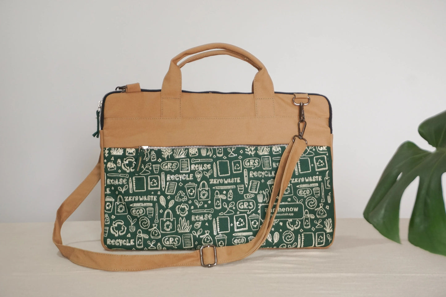 Affordable eco-friendly canvas laptop sleeve with brown strap, sustainable accessory