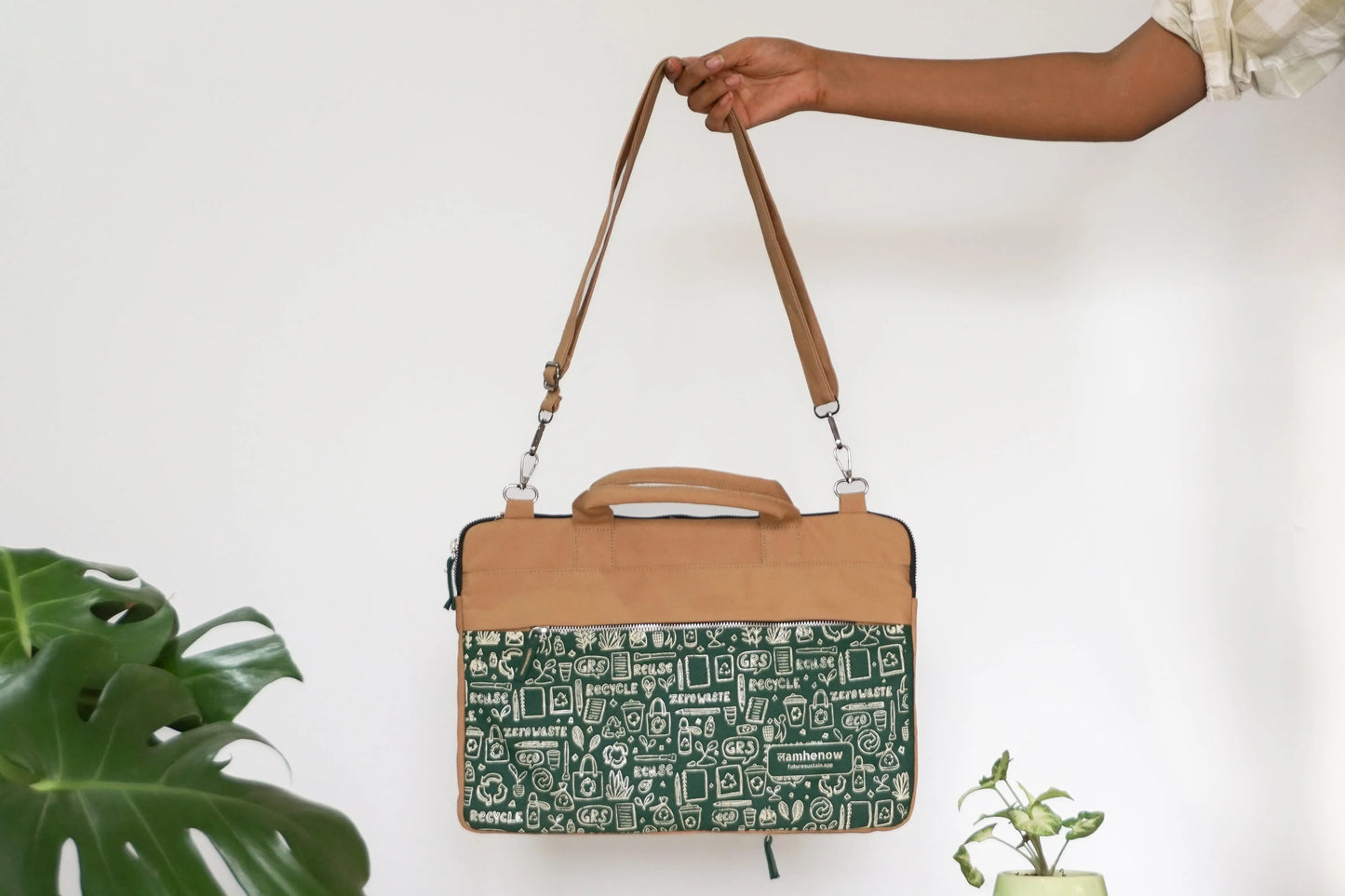 Eco-friendly green canvas laptop sleeve with tan handle, sustainable and affordable