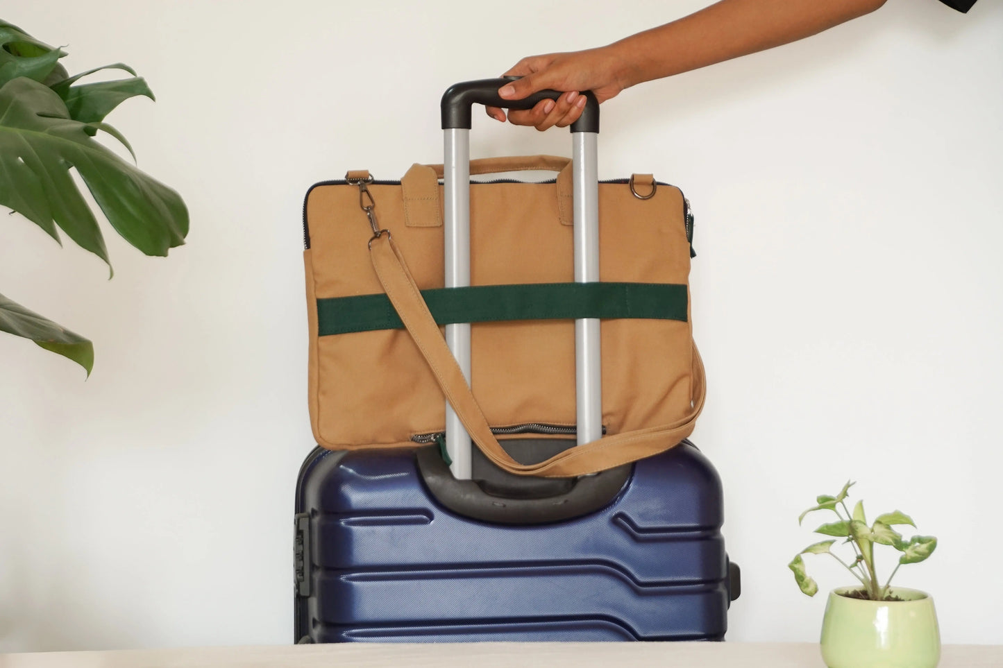 Affordable sustainable green canvas laptop sleeve with brown strap