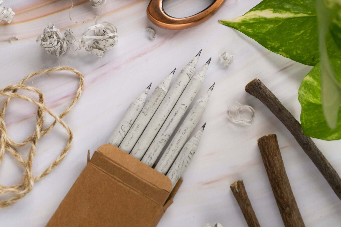 Eco-friendly newspaper pencils stacked on desk, affordable stationery