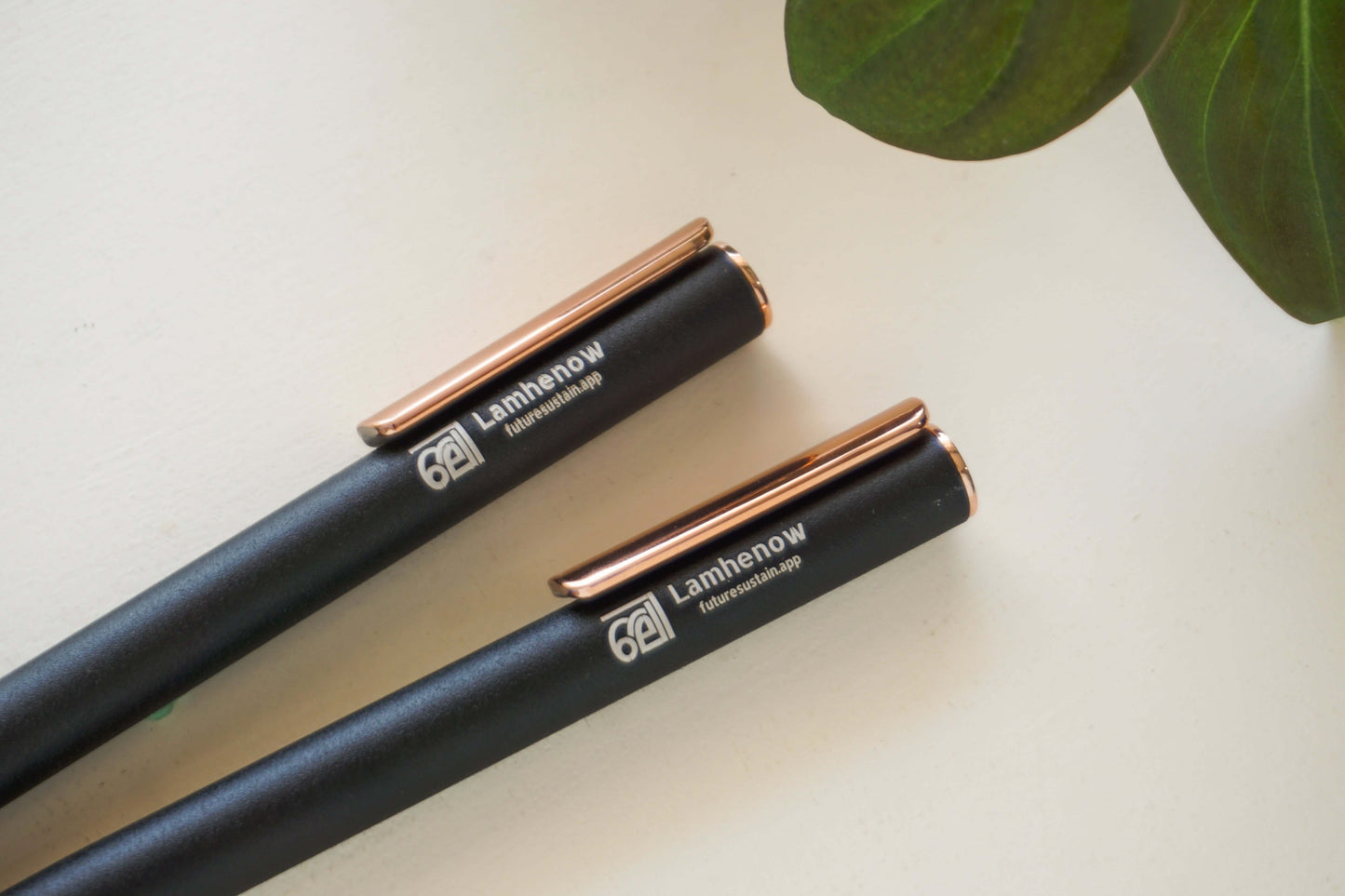 Eco-friendly metal clickable pens on white background
