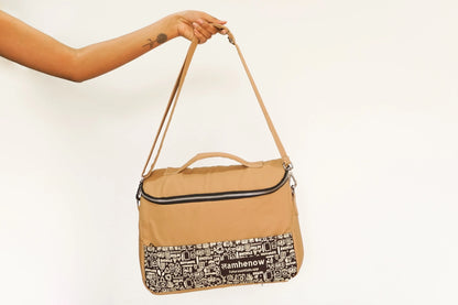 Sustainable canvas laptop bag with tan handle, eco-friendly and affordable
