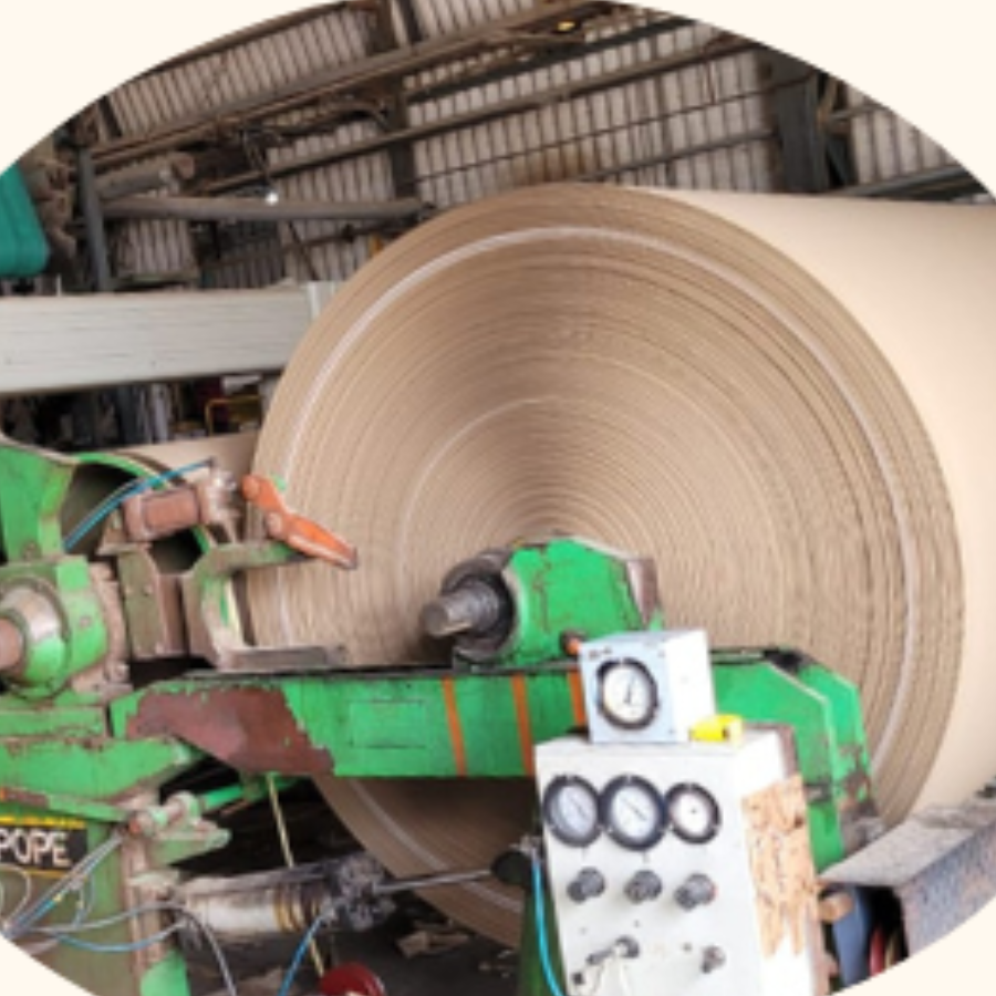 Fresh roll of recycled paper on the mill machine